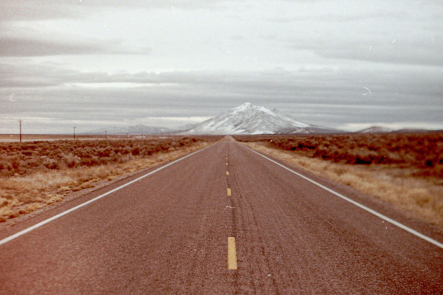 Photo of a road leading to the mountains
